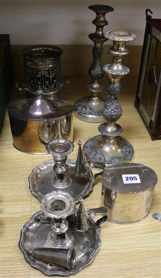 A pair of plated candlesticks, two candle holders, two caddies and a bottle holder